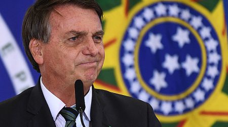 (FILES) In this file photo taken on February 09, 2021 Brazilian President Jair Bolsonaro gestures during the Launch of the "Adote 1 Parque" (Adopt a Park) Program at Planalto Palace in Brasilia. - Bolsonaro apparently ended up admitting that the coronavirus pandemic, which is wreaking havoc in the country, is more serious than a "flu". Though he was seen wearing a mask, ordered millions of vaccines and changed his discredited Minister of Health, observers rule out a radical change of position, as Bolsonaro continues to oppose the confinement measures demanded by scientists to control the disease, which has already left nearly 280,000 dead in the country. (Photo by EVARISTO SA / AFP)